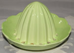 A pale green Carlton Ware juicer top