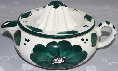 Green flowers on white ceramic jug juicer