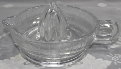 A Cuisena clear glass loop handle juicer