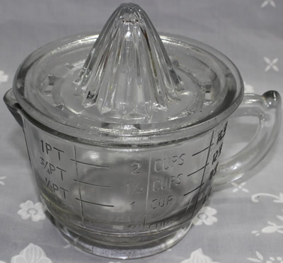 A 2 piece reproduction clear glass juicer