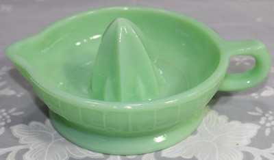 A reproduction jadeite glass jug like juicer