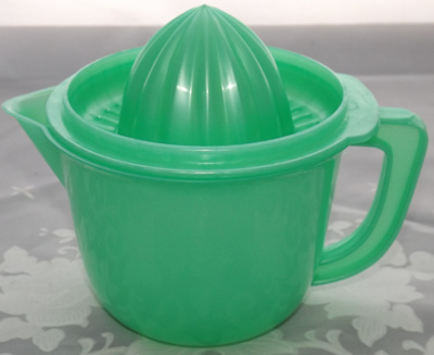 Green plastic juicer on jug with lid