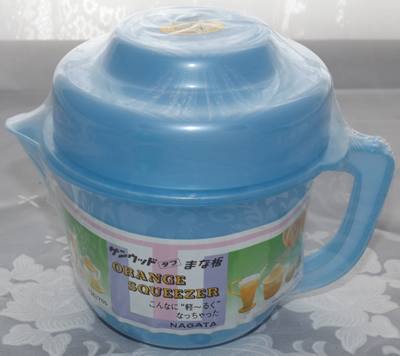 Blue plastic juicer on jug with lid