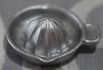 Miniature plastic juicer with offset tab handle