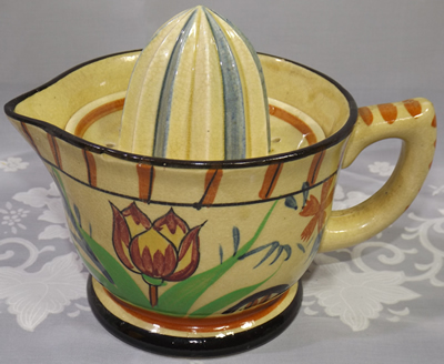 Large cream 2 piece juicer with red and yellow flower etc.
