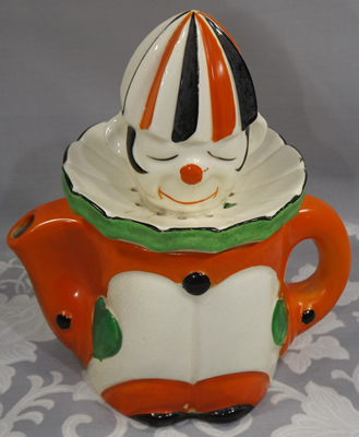 Orange and green with black on white clown juicer