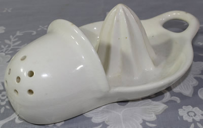 White ceramic hanging 9 hole strainer juicer