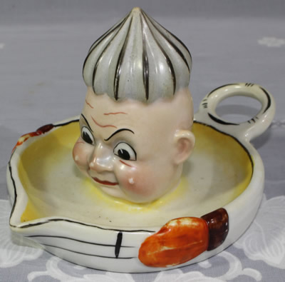 A Goebel frowning face clown saucer juicer