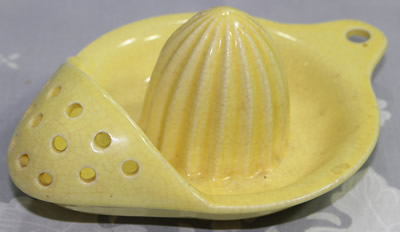 A yellow 12 hole Japanese strainer juicer