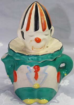 An orange tie on a green and white 6⅛" clown juicer