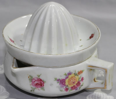 4 different flowers on a white ceramic offset handle juicer
