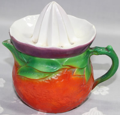 Orange jug, green leaves and purple top ceramic juicer