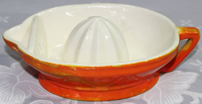 Orange and white juicer with strainer wall