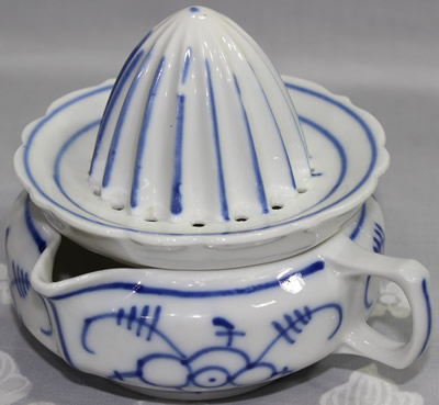Blue on white ceramic German juicer with offset loop handle