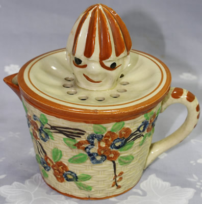 Red and blue flowers on a basket weave jug clown juicer