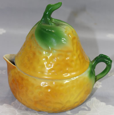 Green leaves on orange on yellow lustre pear shape juicer