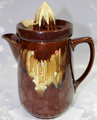 A dark brown with areas of lighter brown drip glaze juicer