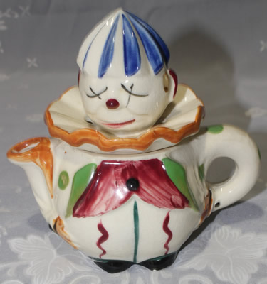 Crossed eyes clown with striped pants blue hat juicer