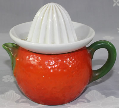 Teapot shape red dark orange peel texture with white reamer juicer