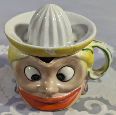 A two piece light brown face shape juicer set