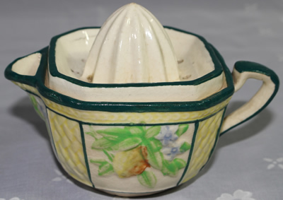 Yellow fruit and blue flowers on ceramic juicer