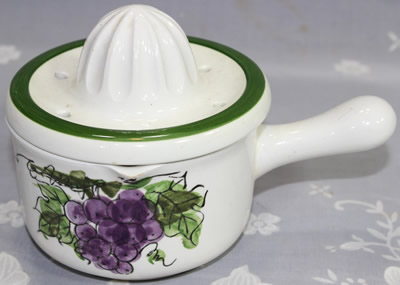 Grapes on white and green ceramic juicer