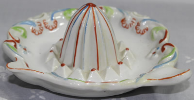 Blue, red & green on white ceramic saucer juicer