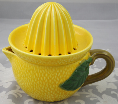 Yellow lemon with brown handle ceramic juicer