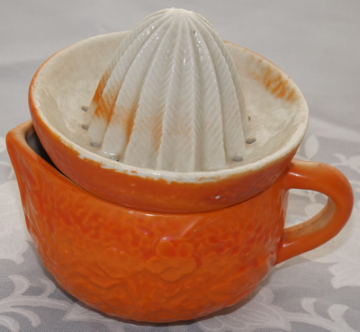 Embossed flowers on an orange ceramic juicer
