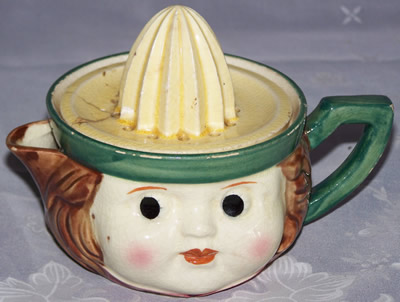 Green and cream top on face juicer