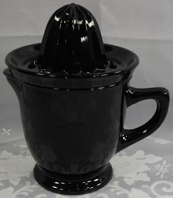 Black glass juicer embossed with a lemon and an orange