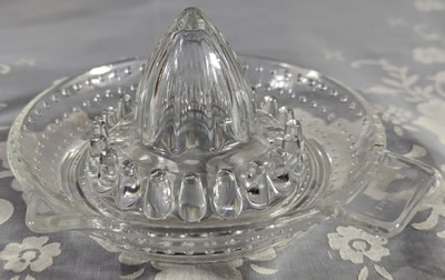 An "arc FRANCE" hobnail clear glass juicer
