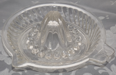 Stylised eagle tab handle clear glass juicer