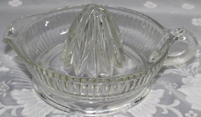 An embossed Anchor Hocking clear glass jug like juicer