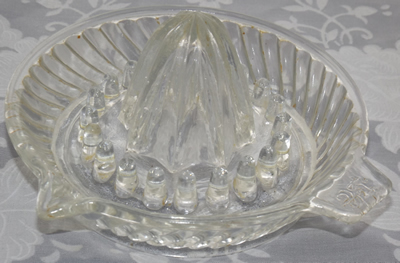 Dragon on tab handle sloping flutes pattern clear glass juicer