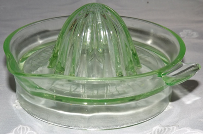 Embossed with 'ORANGE JUICE EXTRACTOR' green glass juicer