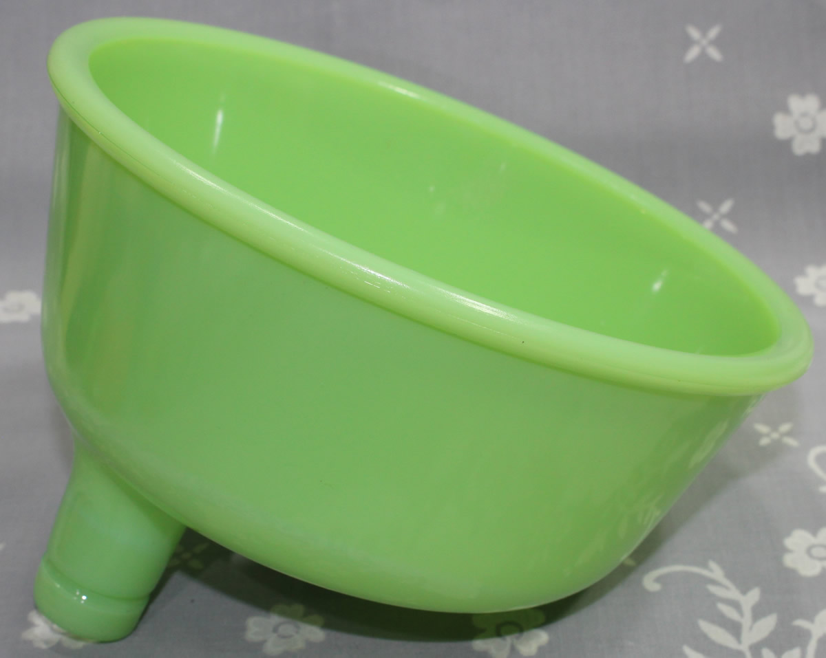 A jadeite or green milk glass juicer attachment