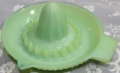A hobnail jadeite with clear glass saucer shape juicer