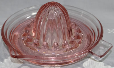 Pink Jeannette Glass Co. juicer with pip collectors 