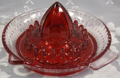 Clear glass with red baked on juicer