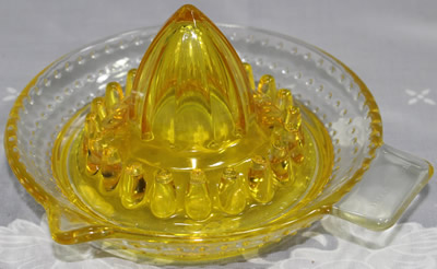 An ARC France yellow and clear glass juicer