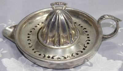 Silverplate stars and crescent moons strainer juicer