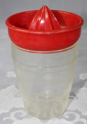 Red plastic Moldex Australia juicer on clear base