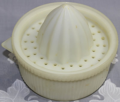 A Stewart Plastics white plastic 2 piece ribbed juicer