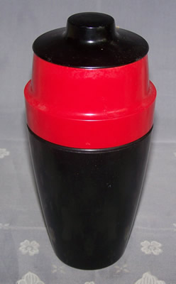 Red and black plastic cocktail shaker with juicer