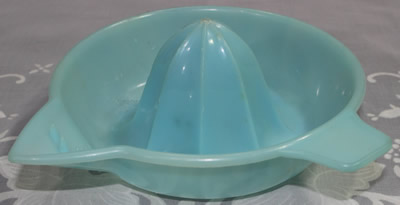 A translucent pale blue plastic Associated Plastics juicer