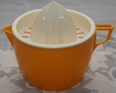 Orange and white plastic 2 piece juicer