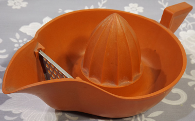 Orange bakelite juicer with metal strainer