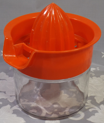 Orange Gemco plastic juicer on glass jar