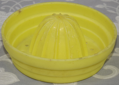 Green juicer on white translucent plastic tumbler